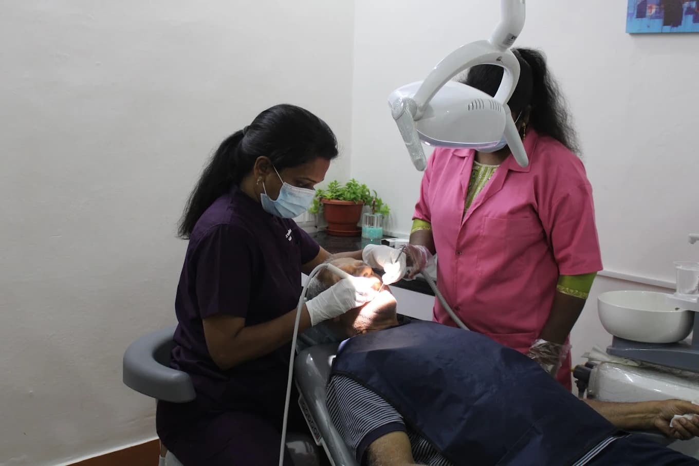 Dentist and assistant providing care to a patient in our modern clinic